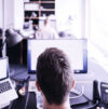 Team member in front of desktop